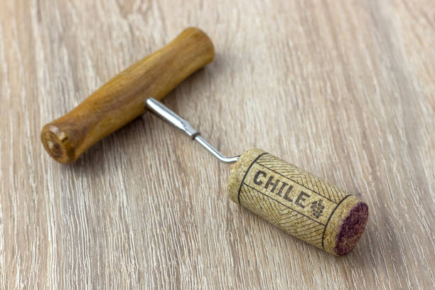 istock A basic corkscrew with a cork on a wooden table. Name of the wine country Chile is written on cork. 1214947962