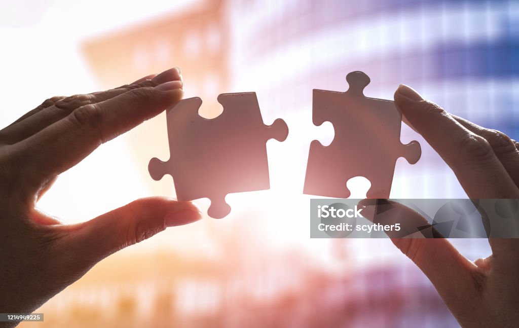 The man holds in his hand a jigsaw puzzle. The man holds in his hand a jigsaw puzzle. Business solutions, success and strategy concept. Connection Stock Photo