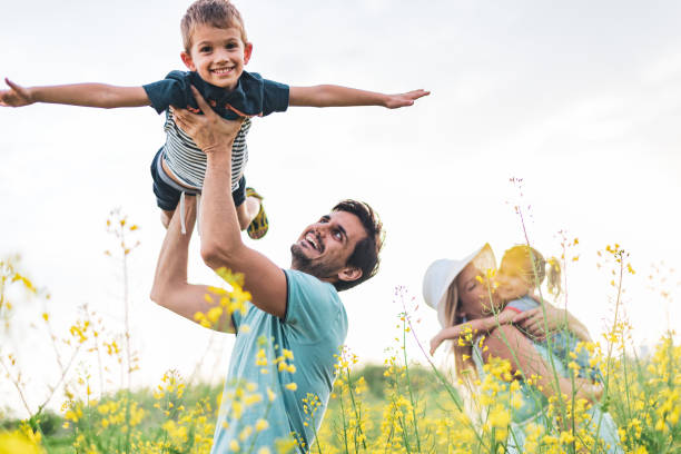 istock Young happy family enjoying nature 1214949239
