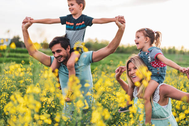 istock Young happy family enjoying nature 1214949753
