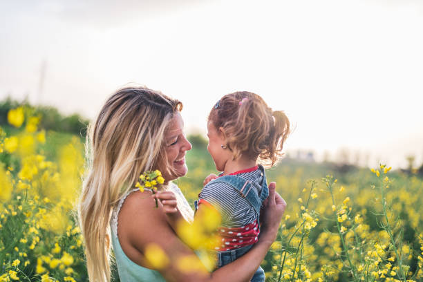 istock Young mother and daughter enjoying nature 1214950547