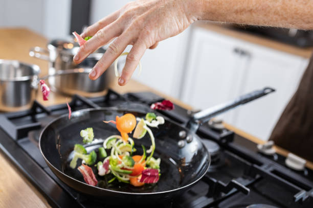 istock Professional Chef Tossing Food 1214950706