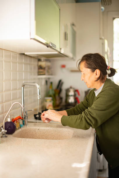 istock Old Woman Washing Her Hand 1214951971
