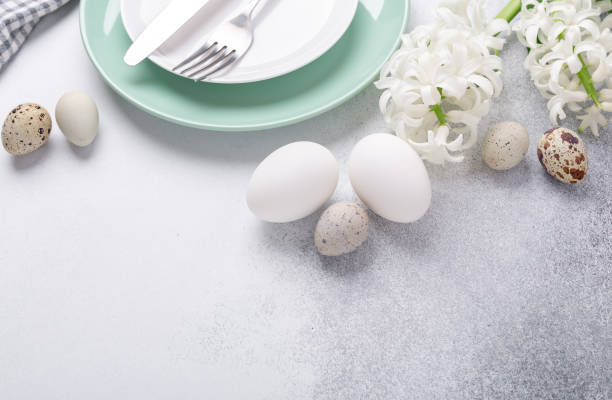 istock Empty mint and white plates, knife and fork on stone background Copy space Top view 1214952916