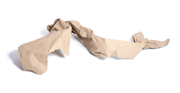 istock Torn piece of packing paper on white background with shadows 1214954407