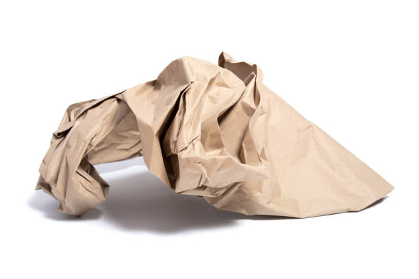 istock Torn piece of packing paper on white background with shadows 1214954410