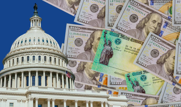 Washington DC Capitol dome with finishing touches on a stimulus bill USA dollar cash banknote on American flag Global pandemic Covid 19 lockdown Washington DC Capitol dome with finishing touches on a stimulus bill Global pandemic Covid 19 lockdown US dollar cash banknote on American flag IRS Headquarters Building stock pictures, royalty-free photos & images