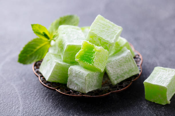 Turkish delight, mint flavour in a copper plate. Grey background. Close up.