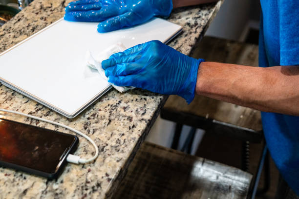 istock Wiping Down Digital Surfaces for Covid-19 1214956614