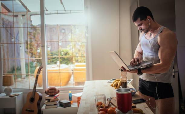 Male athlete in the kitchen Male athlete in the kitchen bodybuilding supplement stock pictures, royalty-free photos & images
