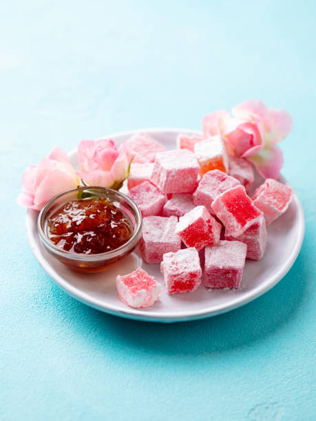 istock Turkish delight, rose flavour in a white plate. Blue background. 1214957679