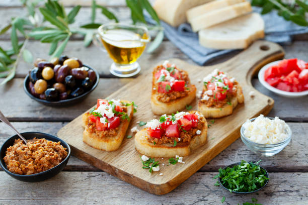 bruschetta with olive tapenade and fresh tomatoes on cutting board. wooden background. - mozzarella tomato sandwich picnic imagens e fotografias de stock