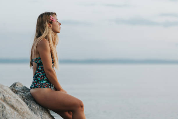 Young woman enjoying sunset on the beach