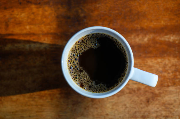 A cup of black coffee on wooden table