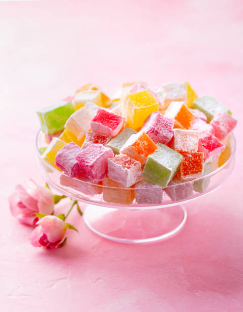 istock Assorted Turkish delights on glass cake stand. Pink background. Copy space. 1214959236