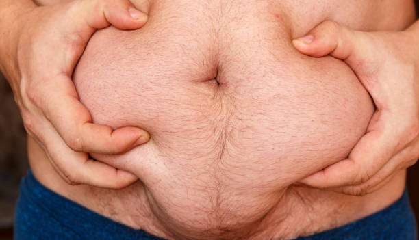 istock Man showing his fat on the stomach 1214961284