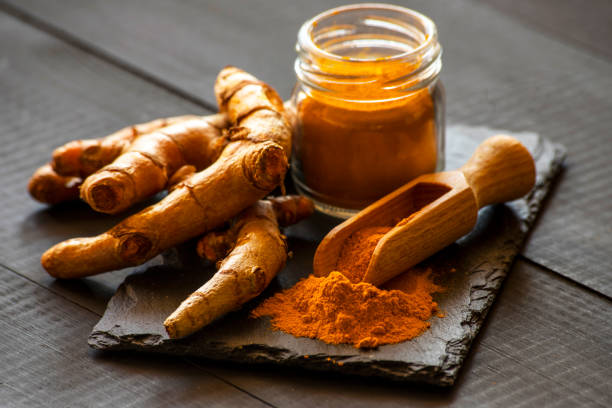 istock Turmeric powder with fresh turmeric root 1214961320