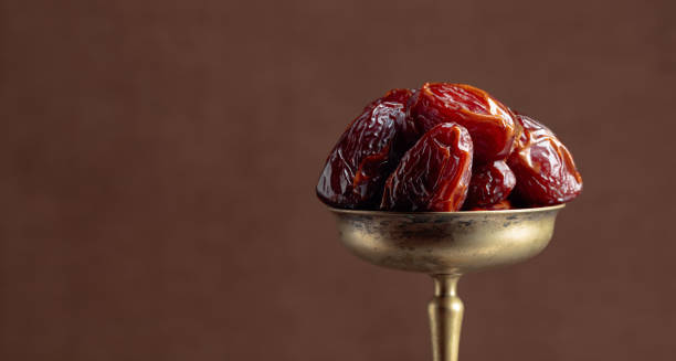 istock Closeup sweet dried dates in brass dish. 1214961364