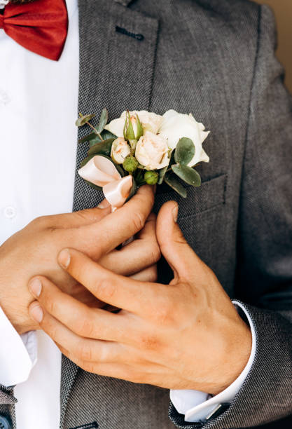 istock The groom holds his boutonniere 1214961448
