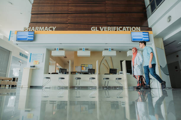 istock Two asian multi ethnicity doctors walking together and having discussion at lobby hospital 1214961449