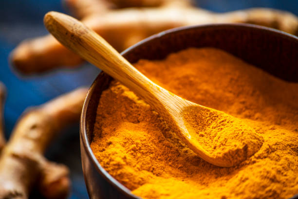 istock Turmeric powder with fresh turmeric root 1214961522