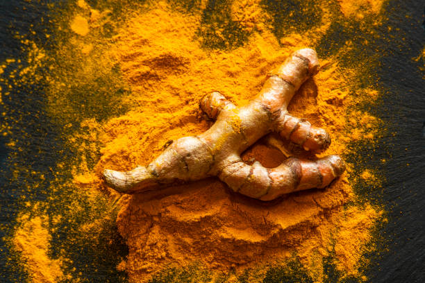 istock Turmeric powder with fresh turmeric root 1214962438