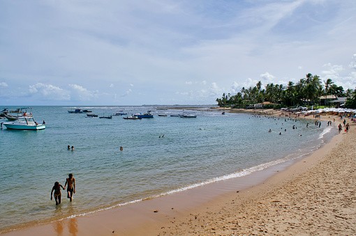 Praia do Forte, Bahia, Brazil. March 15, 2020. People bathing on the beach.