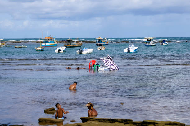 Praia do Forte, Bahia, Brazil. March 15, 2020. People bathing on the beach.