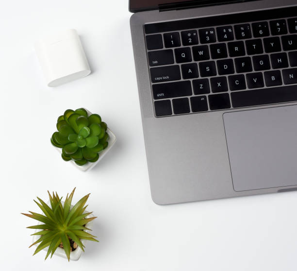 istock open gray laptop stands on a white table, freelancer workplace 1214964480