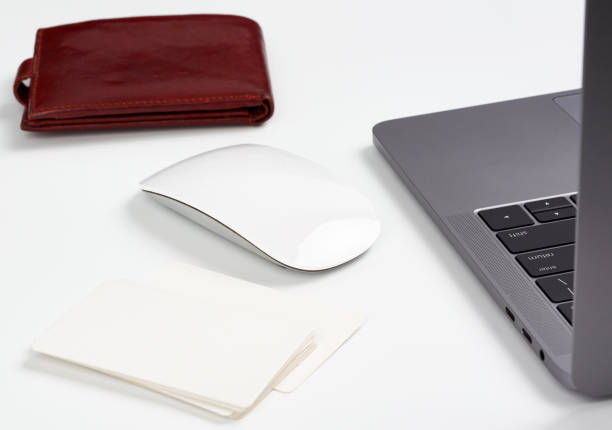 istock open gray laptop stands on a white table, next to a wireless mouse, freelancer workplace 1214964755
