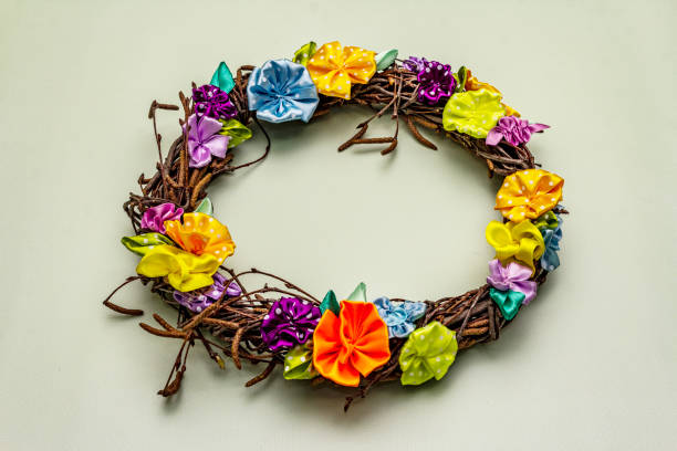 istock Hand crafted Easter wicker wreath with quail eggs and handmade flowers. Birch branches, polka dot satin ribbon. Stay at home concept 1214965100