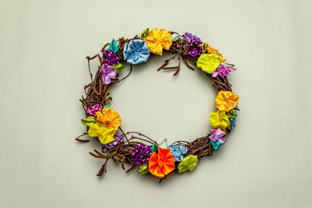 istock Hand crafted Easter wicker wreath with quail eggs and handmade flowers. Birch branches, polka dot satin ribbon. Stay at home concept 1214965111