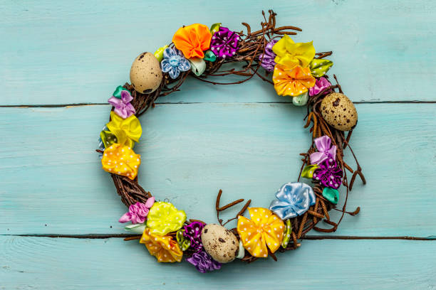 istock Hand crafted Easter wicker wreath with quail eggs and handmade flowers. Birch branches, polka dot satin ribbon. Stay at home concept 1214965508