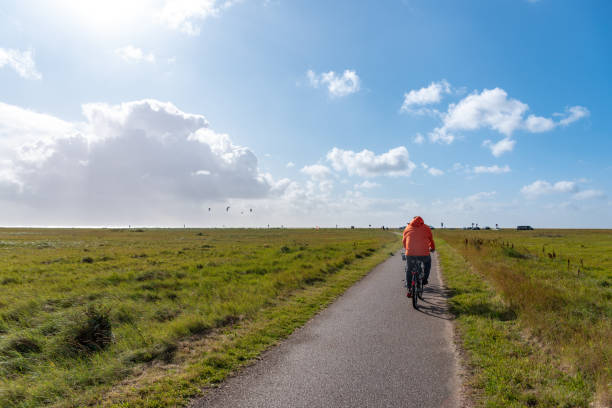 St Peter-Ording, Germany - September 16, 2019: Hiking and cycle path through the salt marshes near St Peter-Ording in North Friesland in Germany.