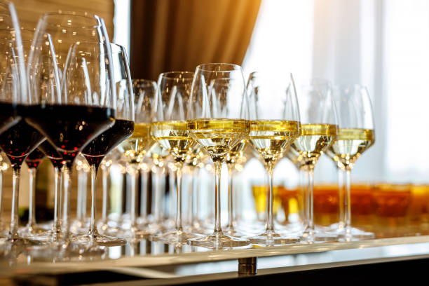 istock Glasses of white wine on bar counter. 1214970344