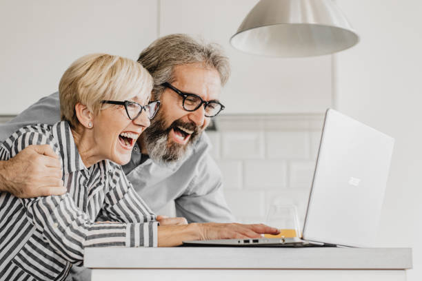 istock Mature couple online shopping 1214970861
