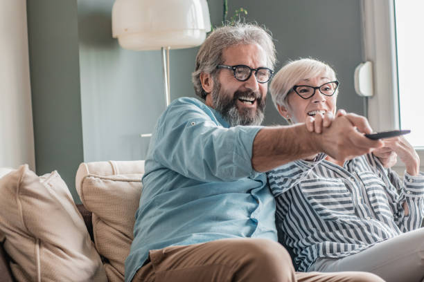 istock Senior couple at home watching TV 1214970894