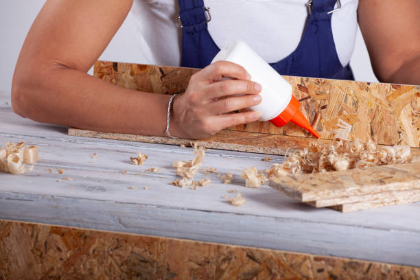The carpenter man checks the quality of the wooden surface . Profession, joinery, woodworking.