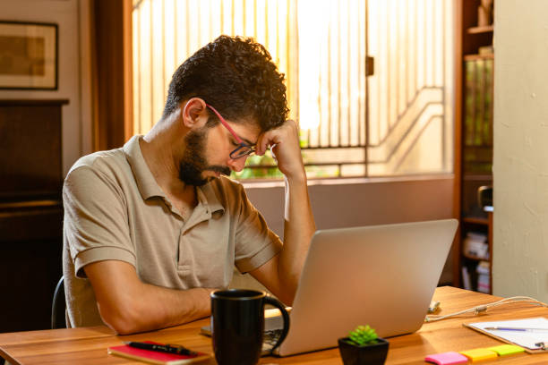 istock Hispanic model tired of his work at home. Concept working at home 1214971911