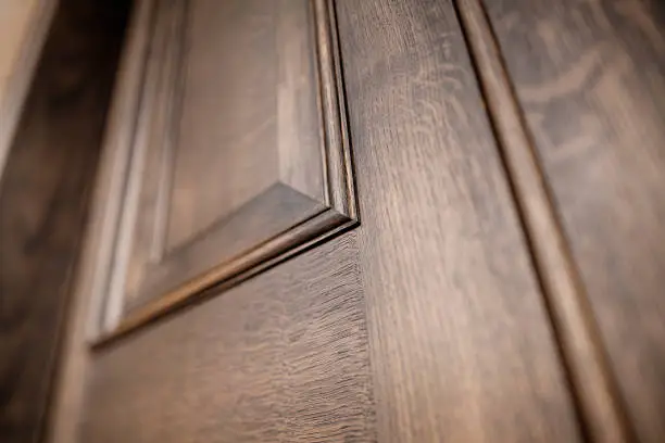 Photo of Close up of detail of panneling on a wooden door with a shallow depth of field