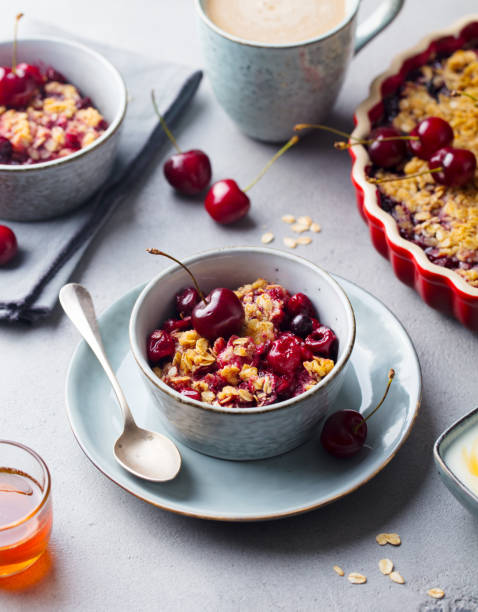 istock Healthy breakfast. Cherry, red berry crumble in bowl. Grey stone background. 1214976169