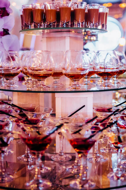 istock View of alcohol setting on catering banquet table, row line of different colored alcohol cocktails on a party, martini, vodka, and others on decorated catering bouquet table event 1214977426