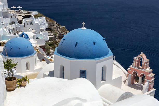 istock Greece. Cyclades Islands - Santorini (Thira). Oia town with typical Cycladic architecture - painted blue cupolas and white walls of houses. The Anastasis Church. 1214977542