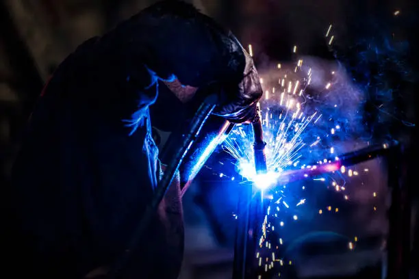 worker using a welding torch