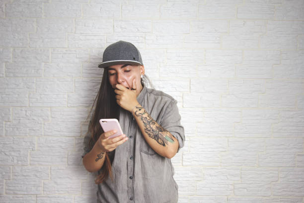 istock Woman looking surprised at cell phone screen 1214978625