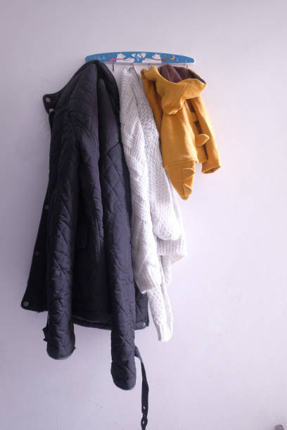istock family cloths handing on wall, close up 1214978669