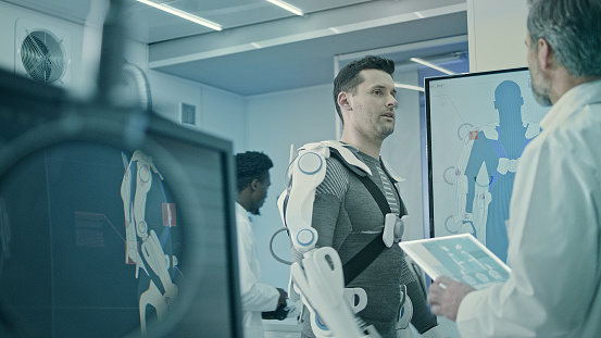 Man wearing and testing exo suits in Laboratory.