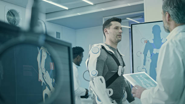 Scientists Working on Powered Exoskeleton Project in Lab. Man wearing and testing exo suits in Laboratory. powered exoskeleton photos stock pictures, royalty-free photos & images