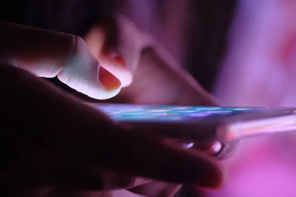 Photo of Close up of women use smart phone at night