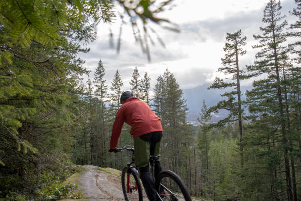 istock Mountain biker rides across rock slabs 1214980726